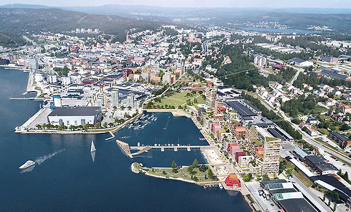 Fotomontage: Flygbild över Örnsköldsvik och havsfjärden där en ny stadsdel träder fram i området från Örnparken österut Sjögatan bortom Strandparken.